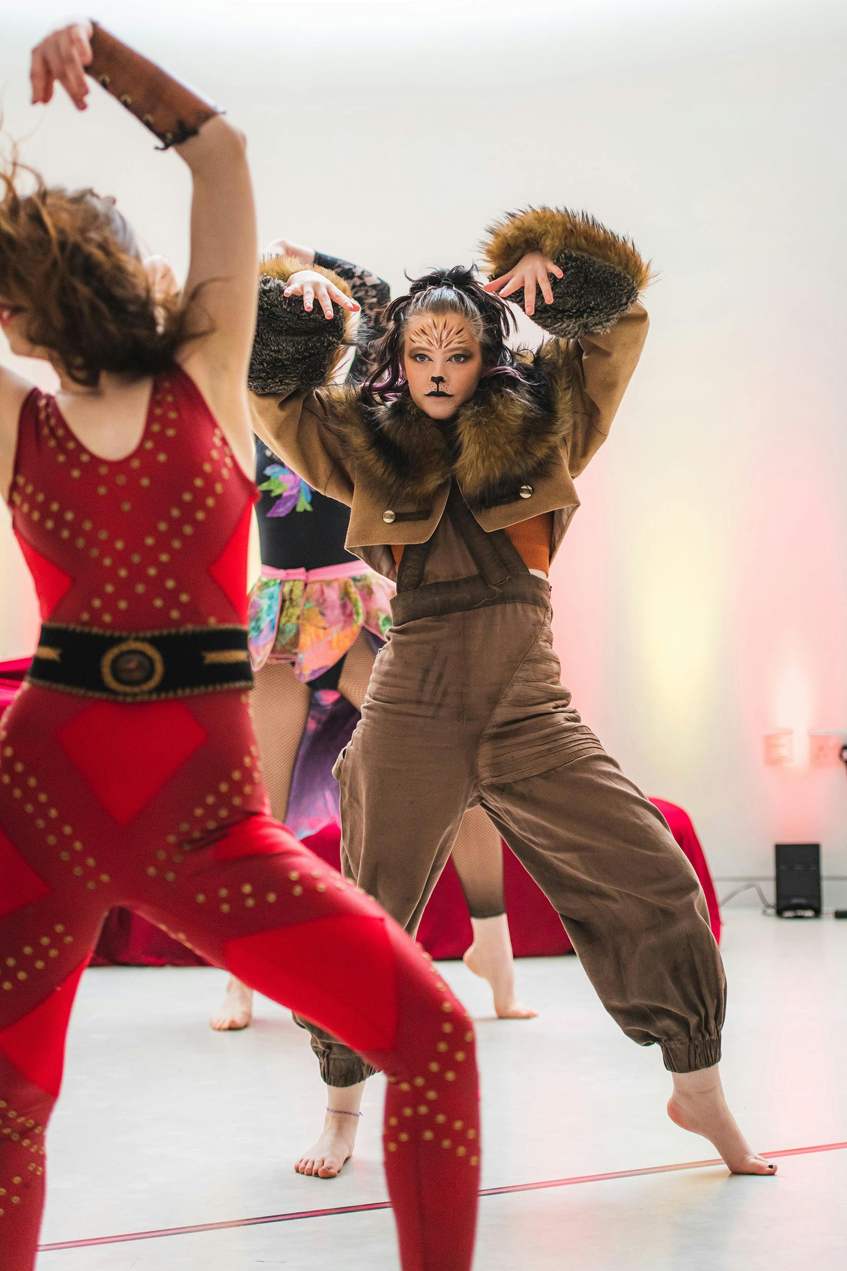 Two dancers performing as part of day of dance – one dancer is dressed like a lion, the other like a stereotypical 'strong man' from a circus