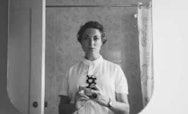 Black and white image of a lady in a mirror