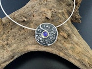 Silver pendant with a blue stone