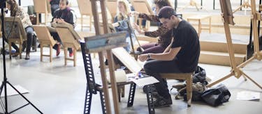 Students painting in the drawing studio