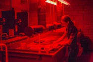 Student working in a darkroom
