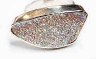 Close up of a ring with lots of very colourful stones set in it