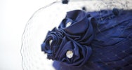 Close up of a jewelled flower feature on a hat