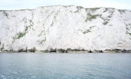 Close crop of white chalk cliffs and calm blue sea