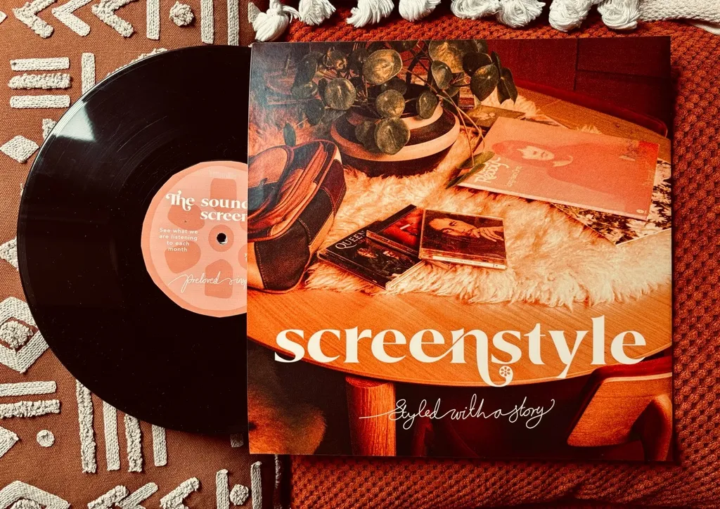 Black vinyl record beside orange album cover reading "screenstyle" with layered geometric patterns and vintage imagery.