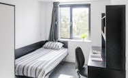 Bedroom featuring a single bed and a black desk and chair