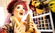 Alumna Mea Warburton, holding up a pair of shoes