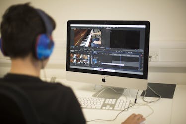 Student using Adobe Premier Pro on an iMac, making a short film