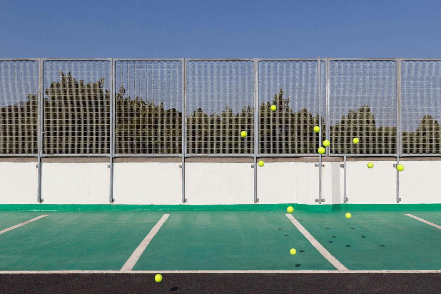 Tennis balls floating on a tennis court