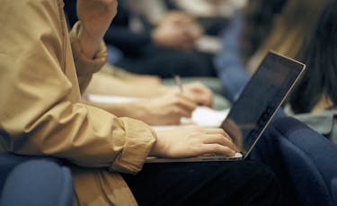 Student using a laptop during a lecture