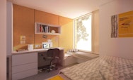 Single bedroom inside Campus Halls featuring a bed and study area
