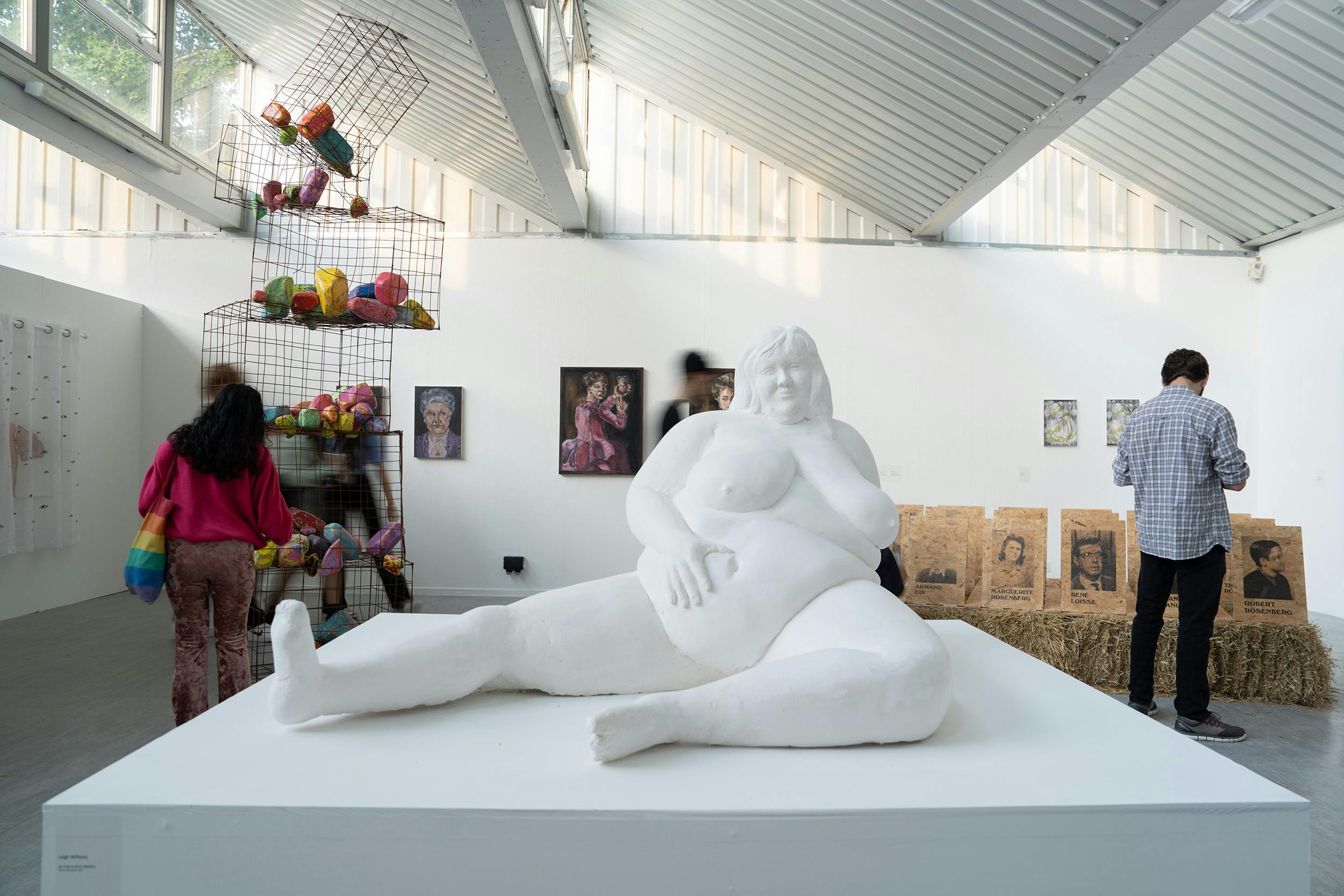 fine art studios over the summer shows – there's a large sculpture of a naked figure proudly resting their hand on to their bare belly