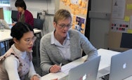 Tutor giving tutorial to student