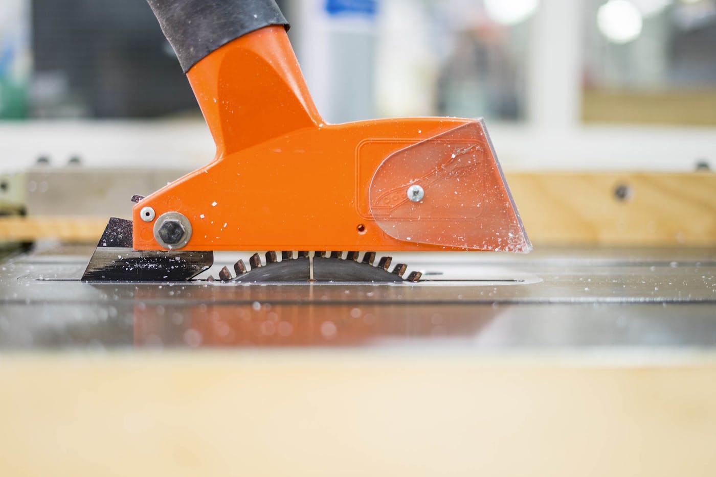 A bright orange guard over a circular table saw