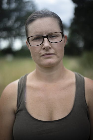 Portrait of a women wearing a dark green tank top and glasses