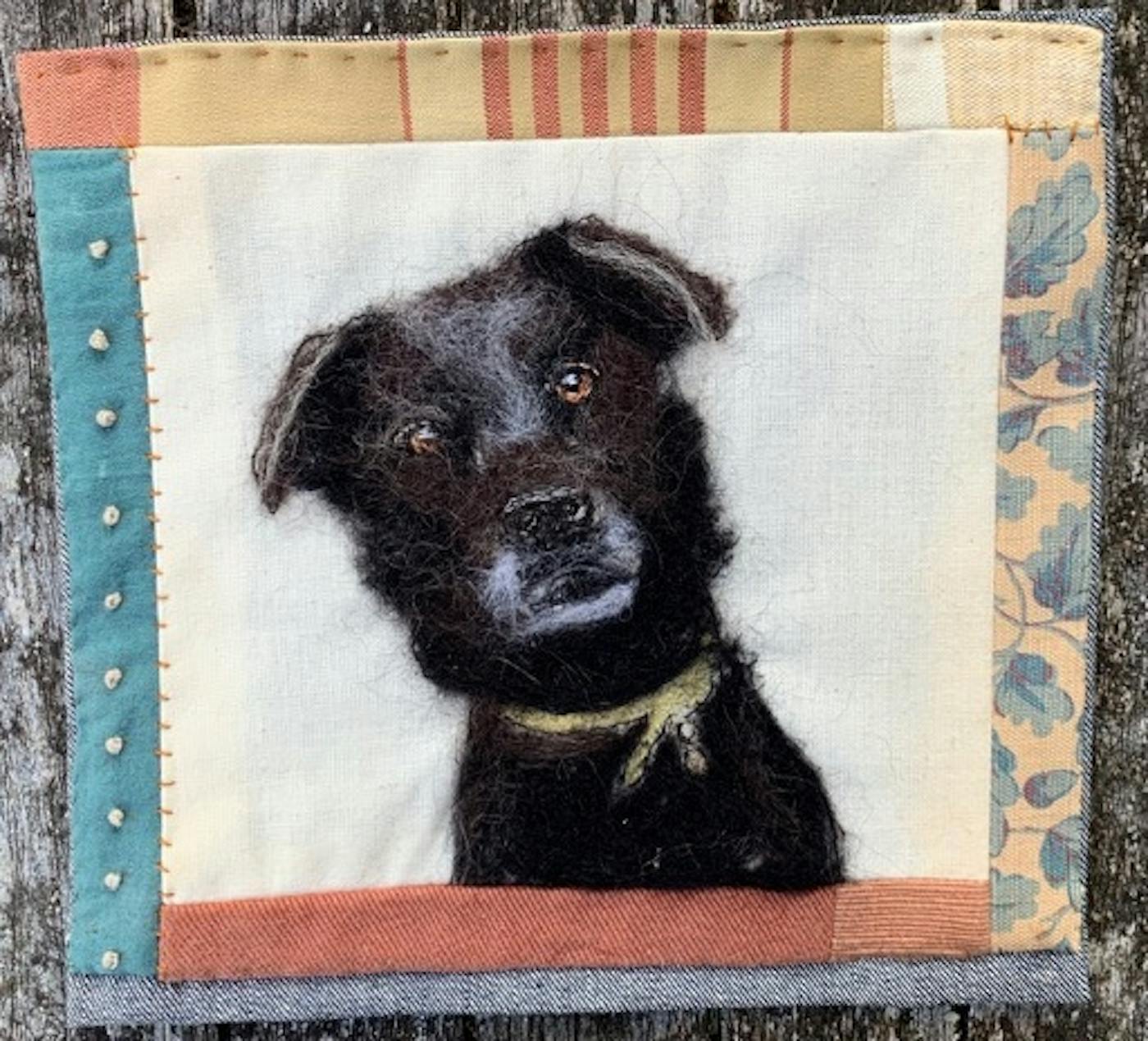 Painting of a black dog with a border made from pastel coloured, patterned fabric