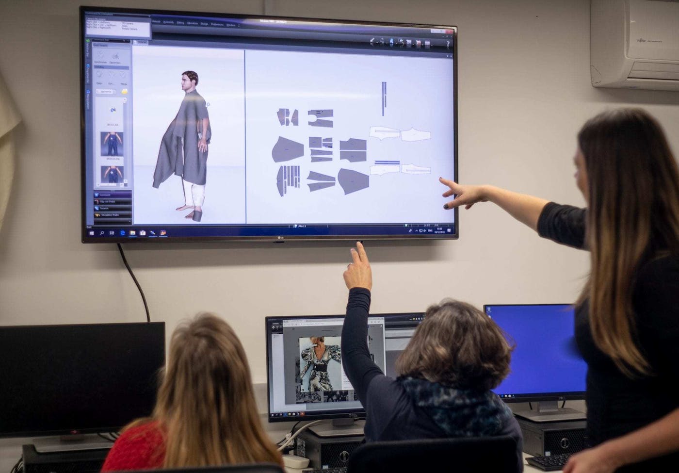 Students learning how to create designs on CLO