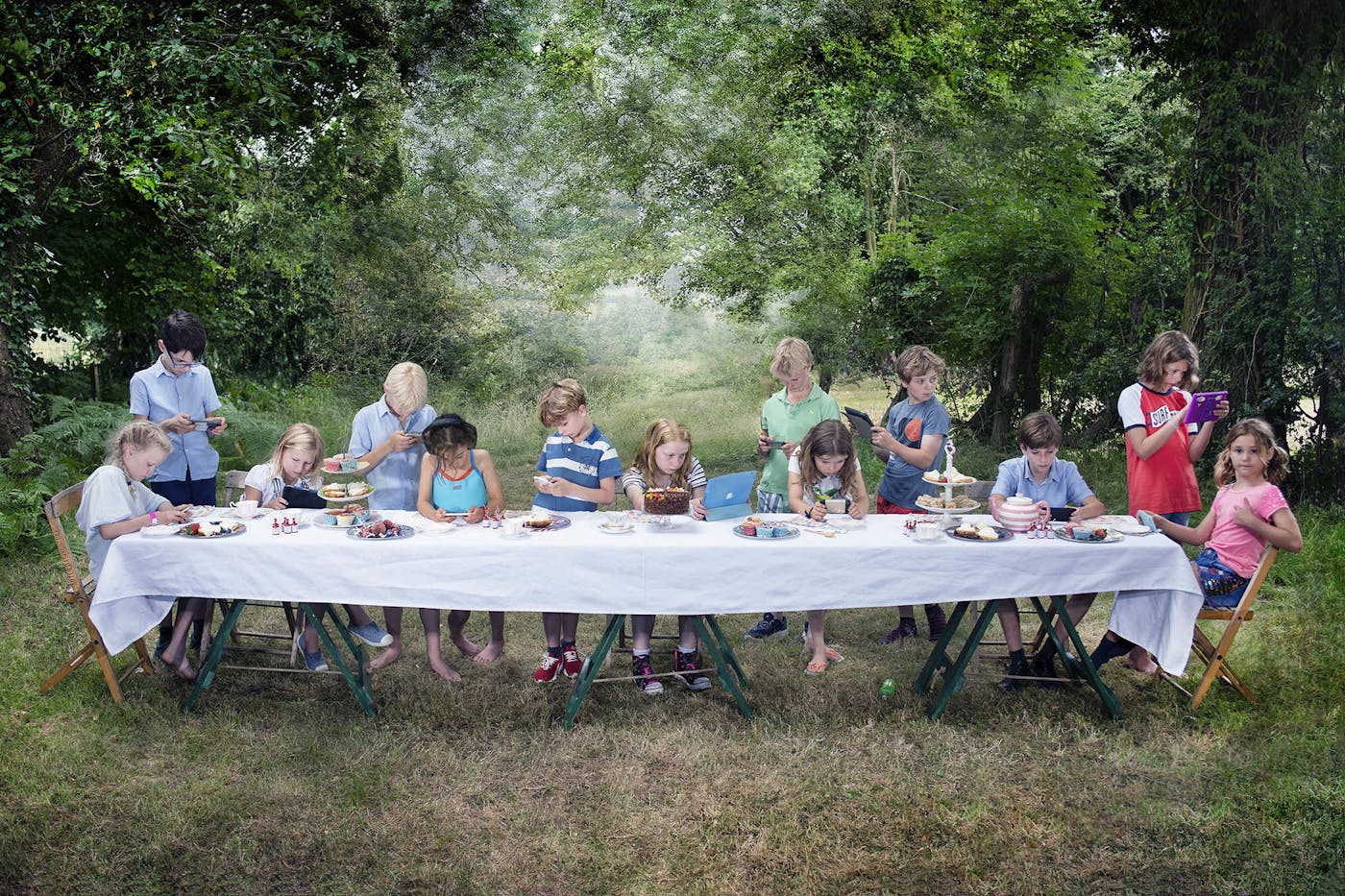Image of children at garden tea party reminiscent of Da Vinci's The Last Supper painting.