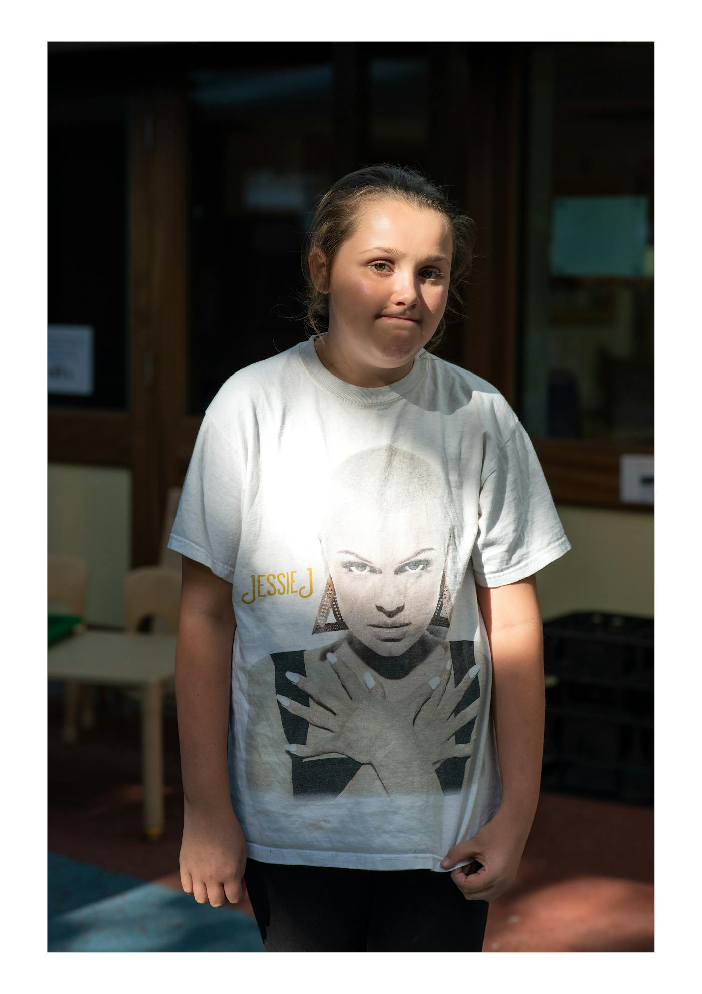 Photography of a girl wearing a graphic shirt.