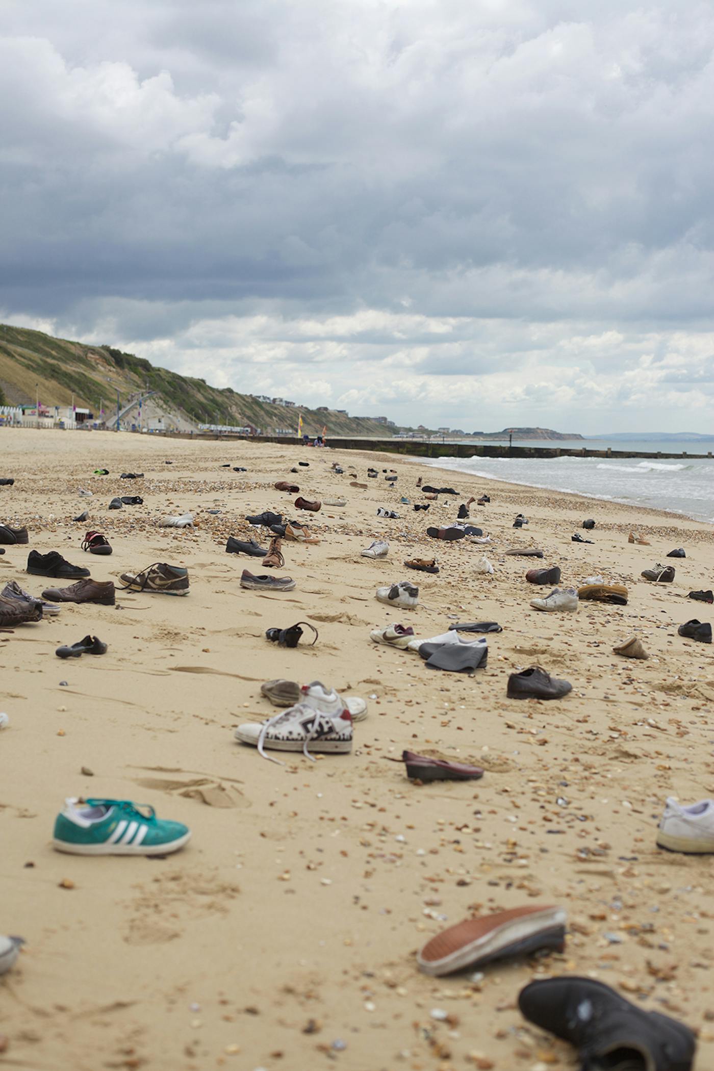 Multiple shoes scattered across Bournemouth Beach