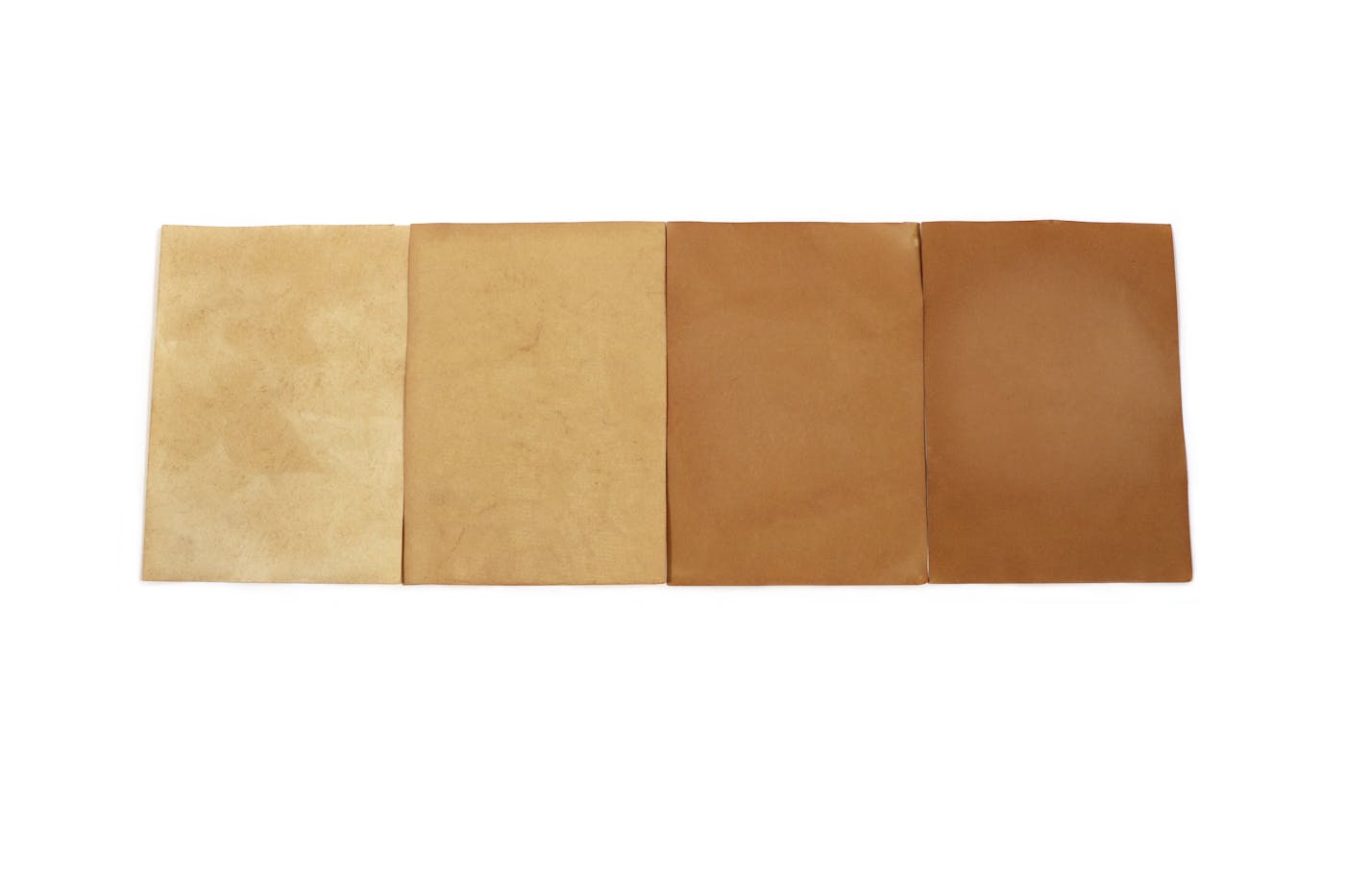 Four pieces of paper different shades of brown