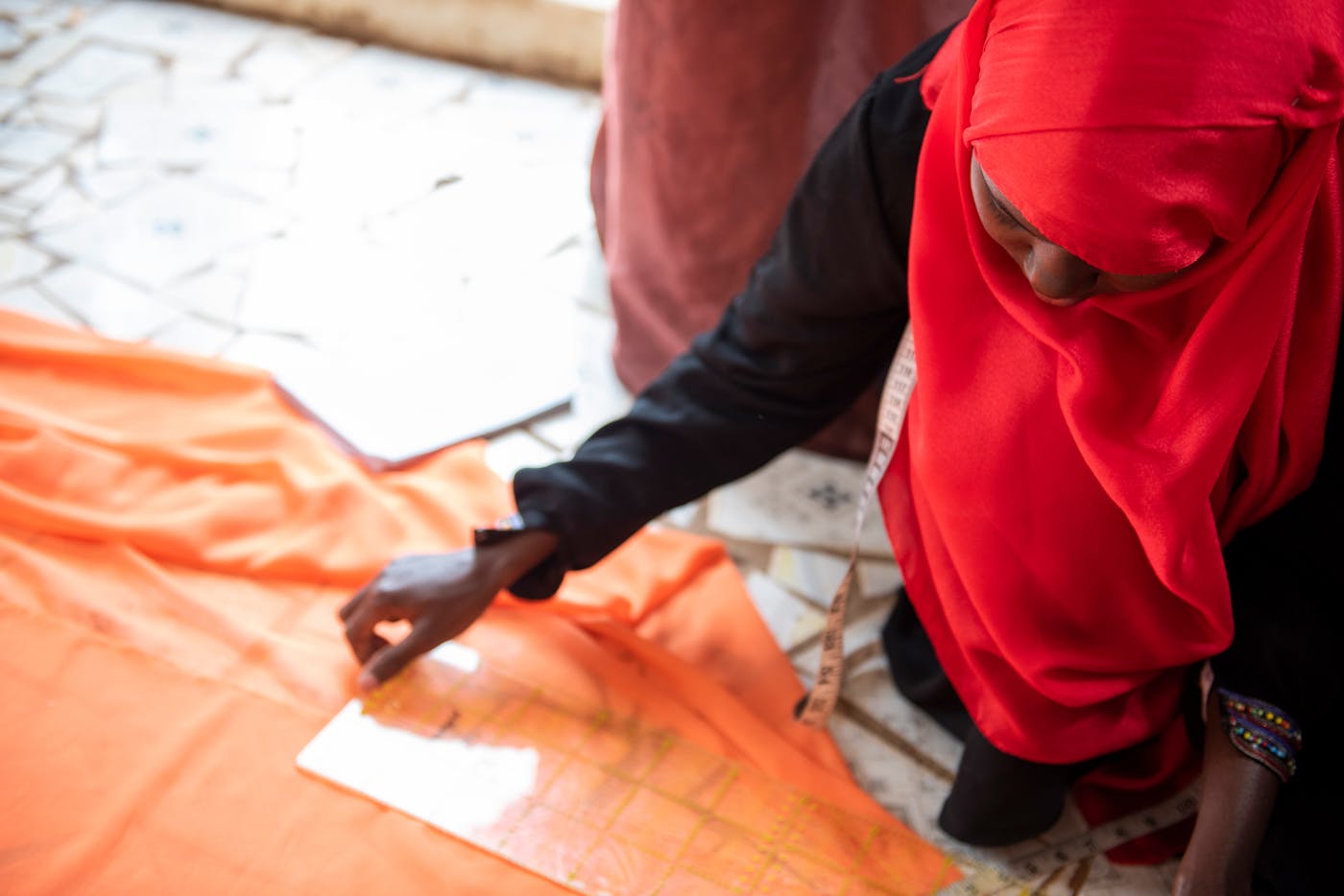 Women looking at orange material