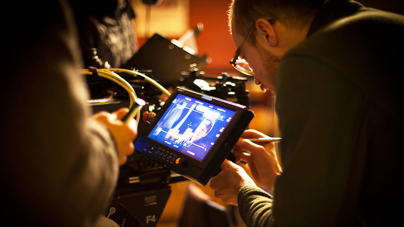 Man setting a camera to the right focus
