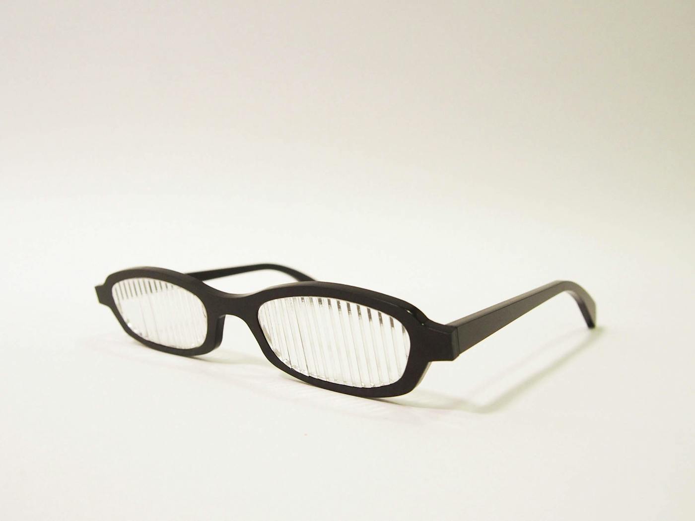 A pair of black glasses with disrupted lenses