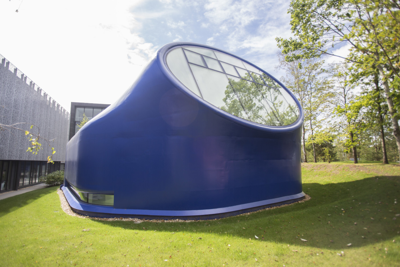 The outside of the drawing studio – a blue one-storey building with a large oval window
