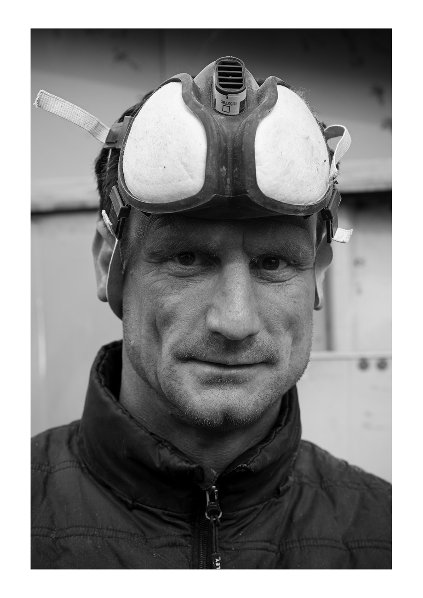 Black and white image of man wearing a helmet