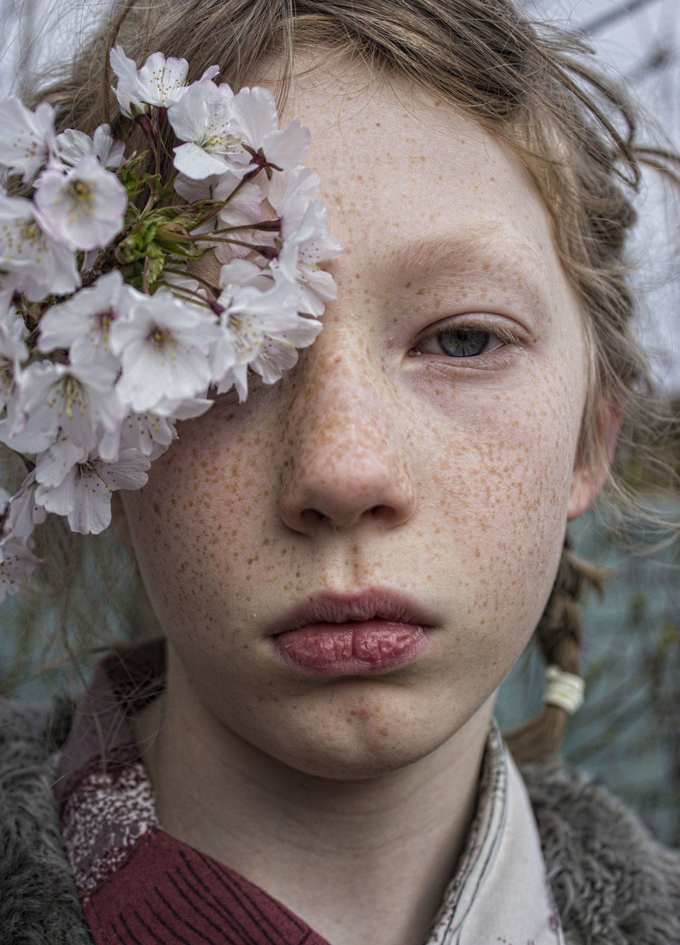 Girl with flowers covering her left eye