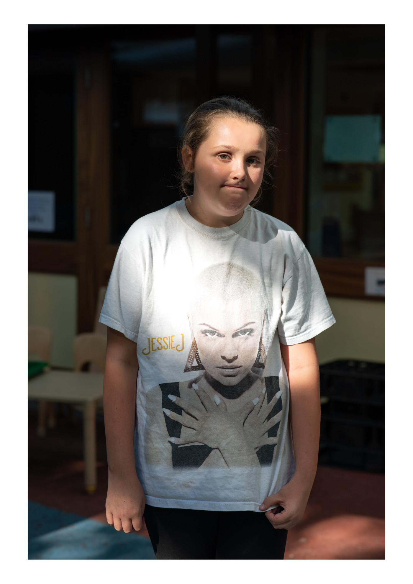 Photography of a girl wearing a graphic shirt.