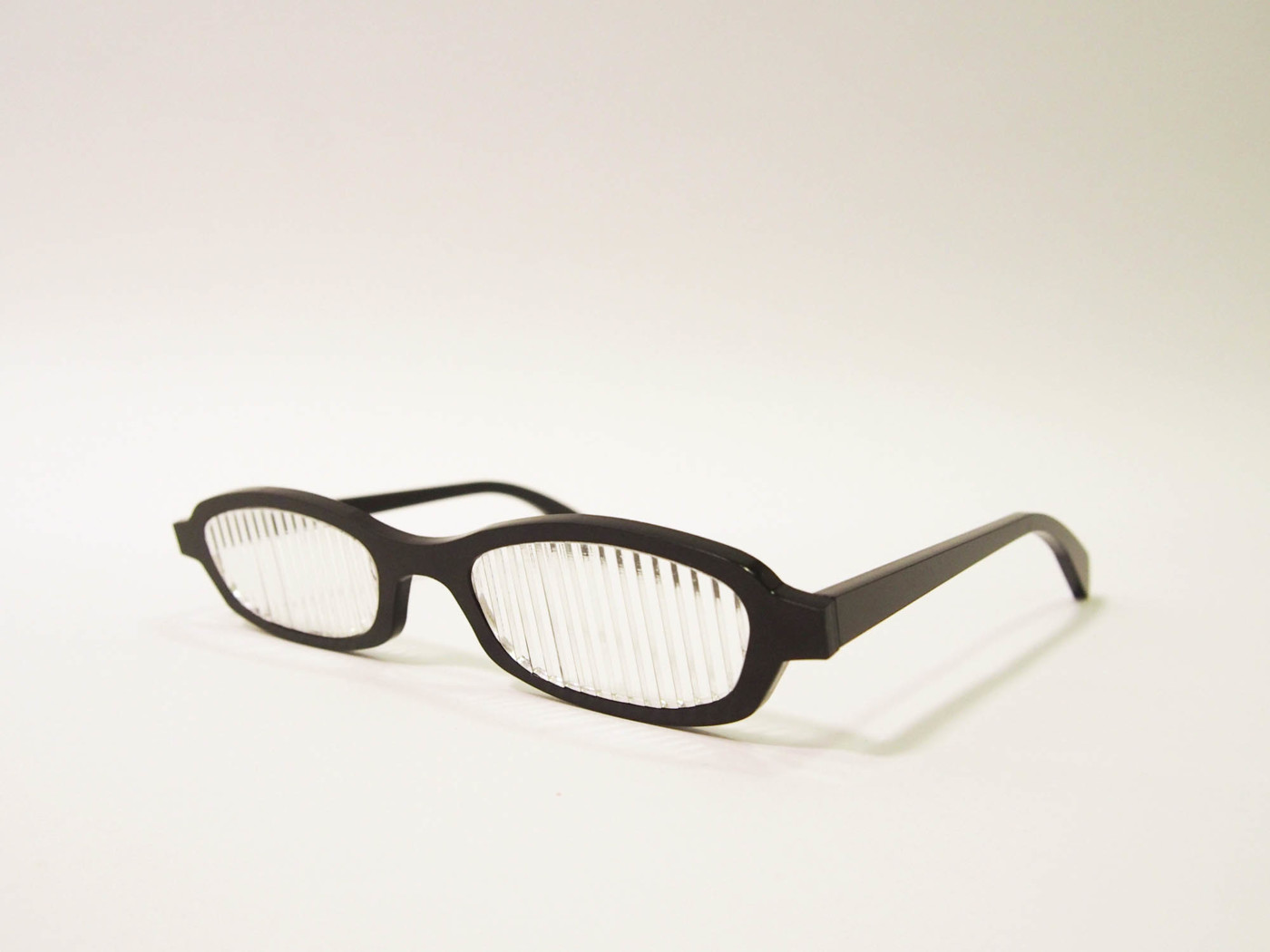 A pair of black glasses with disrupted lenses