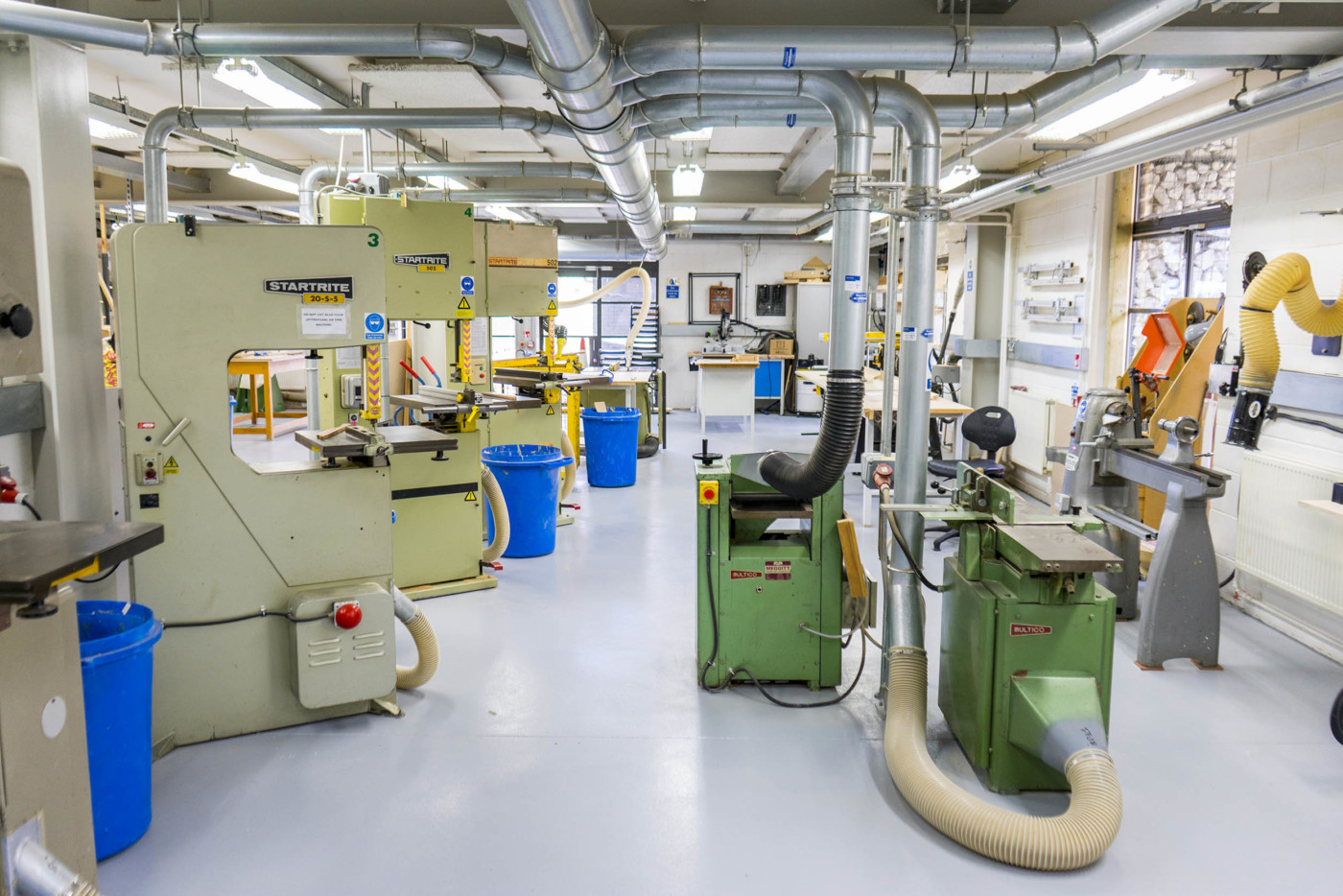 a bright and airy workshop with table saws